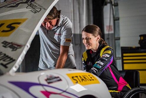 Racing drive Nathalie McGloing working on his racing car